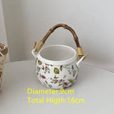 Yeknu  Ceramic Pot Basket with Hand Woven Rattan Pole Handle Bowl Basket Organizer Box Makeup Brushes Pens Remotes Coffee Table Storage