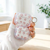 Yeknu  Minimalist red hollow heart-shaped transparent TPU shell shock-absorbing headphone cover with metal keychain